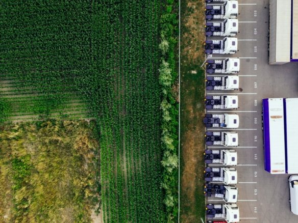 parked vehicles on parking lot near plant field