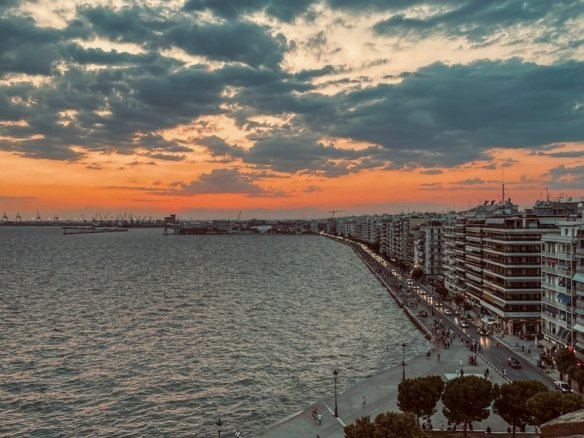 a sunset view of a beach and a body of water